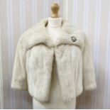 White mink short evening jacket with diamante brooch attached, three-quarter length bell sleeves