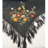 Black silk embroidered shawl lined in cream silk with deep embroidered fringe and floral design to