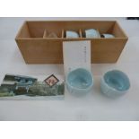 Kaiji Tsukamoto (1912-1990) a set of five pale celadon ground porcelain sake cups in fitted