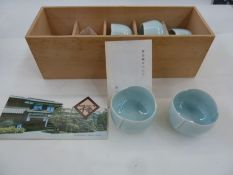 Kaiji Tsukamoto (1912-1990) a set of five pale celadon ground porcelain sake cups in fitted