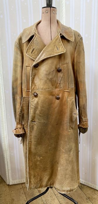 Vintage leather car coat with heavy wool lining, buckle straps to the sleeves, belt with buckle (