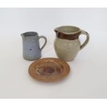Three pieces of The Friars, Aylesford studio pottery to include a jug with tenmoku and oatmeal