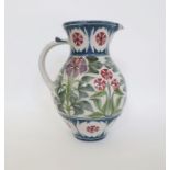 Laurence McGowan (b.1942) a stoneware pitcher with floral decoration on white ground, signed to base