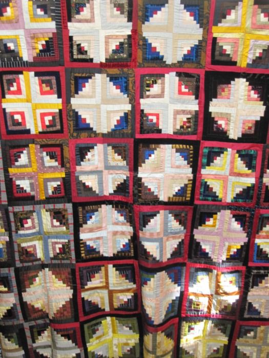 Hand-made brightly-coloured squared patchwork quilt (unsown edges) together with other fabric items,