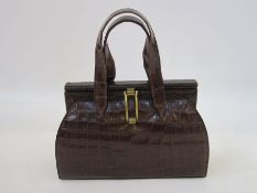 Vintage crocodile handbag with brass loop fitting, the fixed frame covered in leather, double