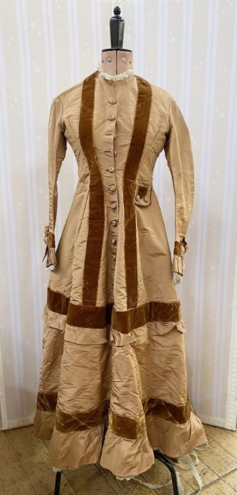 Victorian tan-coloured satin walking dress with brown velvet detail, caramel-coloured buttons, the