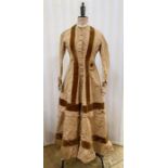 Victorian tan-coloured satin walking dress with brown velvet detail, caramel-coloured buttons, the