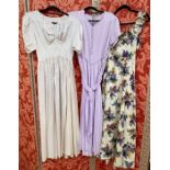 Seven various 1950's satin evening dresses to include a cream ground printed with lilacs,