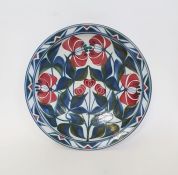 Laurence McGowan (b.1942) a stoneware pottery bowl with floral decoration on white ground, signed to