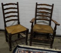 Set of six 20th century oak ladderback dining chairs with rush seats, including two carvers (6)