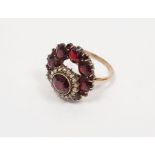 A gold, garnet and seedpearl ring, (unmarked), 7g approx.