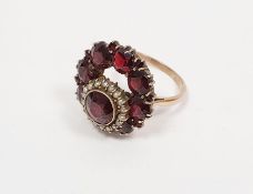 A gold, garnet and seedpearl ring, (unmarked), 7g approx.