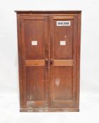 20th century stained pine two-door wardrobe with rectangular top over two panelled doors, on