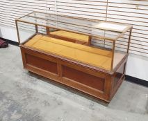 Early 20th century display cabinet with four-sided glass top section, copper-bound with sliding