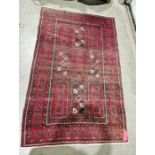 Eastern style red ground rug with central geometric pattern with multiple geometric borders 236cm