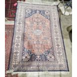 Persian style red rug with central floral design with multiple geometric and floral borders 192.