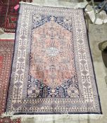 Persian style red rug with central floral design with multiple geometric and floral borders 192.