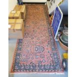 Persian pink ground runner with centralised floral pattern with herati border flanked by floral