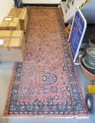Persian pink ground runner with centralised floral pattern with herati border flanked by floral
