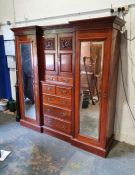 Late Victorian/early Edwardian breakfront wardrobe, the moulded cornice above centre of two cupboard
