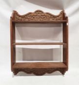 A carved oak wall-hanging two-shelf bookcase