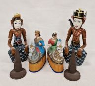 Pair of Eastern wooden carved seated figures and two Eastern papier-mache models of male and