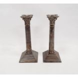 Pair of 1960's silver weighted Corinthian column candlesticks with on a square stepped base, maker