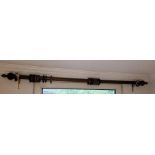 Wooden curtain rail with wooden rings and turned ends and a pair of brass rail holders Condition