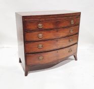 Georgian mahogany bowfront bachelor's chest with brushing slide above four long graduated drawers,