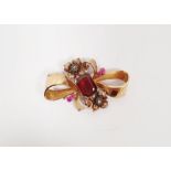 A gold bow brooch, set with garnet and diamonds, 6.5g approx.