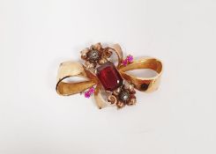 A gold bow brooch, set with garnet and diamonds, 6.5g approx.