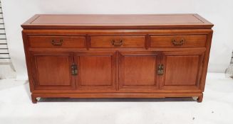 Modern Chinese hardwood sideboard with three drawers above four cupboard doors, 87cm x 183cm x 50.
