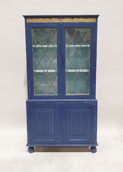 20th century painted cabinet, the leaded glazed doors enclosing shelves above two linenfold cupboard