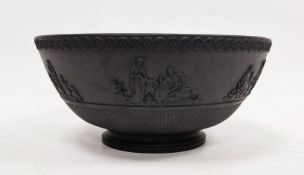 Black basalt bowl in the manner of Wedgwood with decorated rim, the body with applied moulded scenes