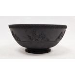 Black basalt bowl in the manner of Wedgwood with decorated rim, the body with applied moulded scenes