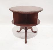 20th century mahogany two-tier circular revolving bookcase , the circular top with gadrooned edge