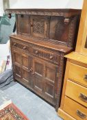 20th century stained oak court cupboard, with carved canopy, above single cupboard door, base of two