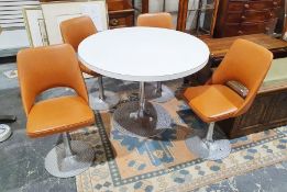 Mid-century modern formica-topped dining table with stainless steel stemmed base to circular