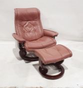 Pair of Ekornes pink leather reclining chairs on circular bases with matching footstools