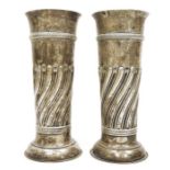 Pair of Victorian large silver vases, cylindrical repousse decorated on circular feet, London 1897