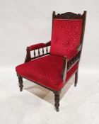 Late Victorian/Edwardian armchair with red upholstered seat, back and armrests, on turned and ringed