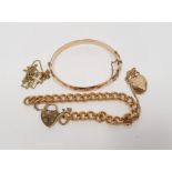 9ct gold bronze core bangle, a rolled gold chain bracelet with padlock clasp, a 9ct gold and metal