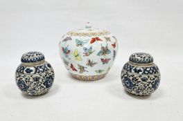 20th century lidded ovoid pot in the Chinese taste, decorated with butterflies and two ginger
