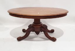 20th century walnut oval tilt-top loo table on faceted column, ogee legs, 74cm x 148cm x 102cm