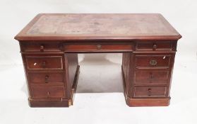 Early 20th century mahogany desk, the leather inset top above nine assorted drawers, on plinth base,