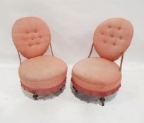 Pair of early 20th century low-seated bedroom/nursing chairs, pink upholstered with circular
