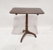 19th century mahogany tripod table, the rectangular top with rounded corners, on turned supports