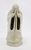 Chinese ceramic figure of monk in prayer with faint mark to base, 24cm high