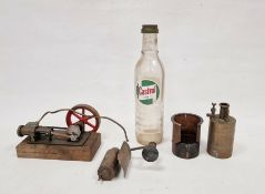 Vintage static steam engine and a vintage glass Castrol motor oil bottle (2)