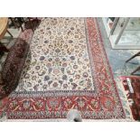 Eastern style cream ground carpet with central floral pattern with multiple herati and floral